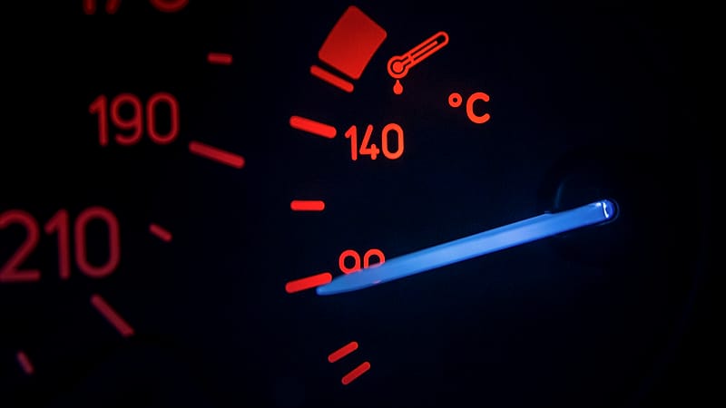 A tablet mounted to a dashboard bracket showing a grid of colored duty status bars beside a gear selector.